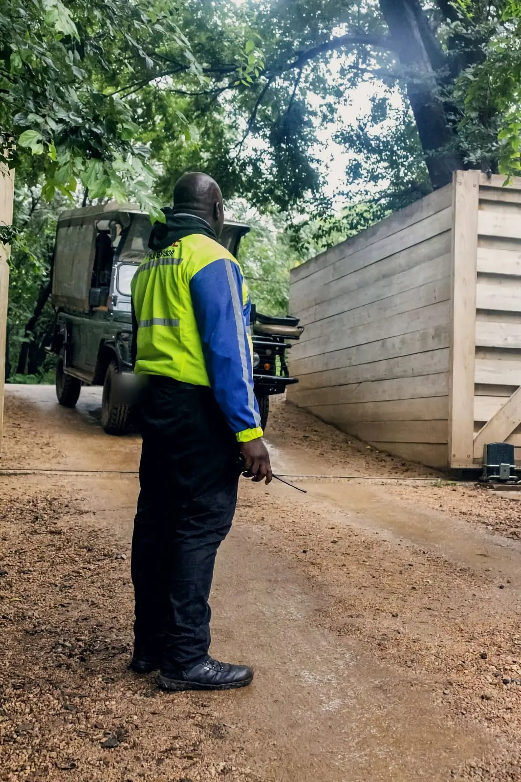 ZENOSC supervisor at a lodge gate as a vehicle passes