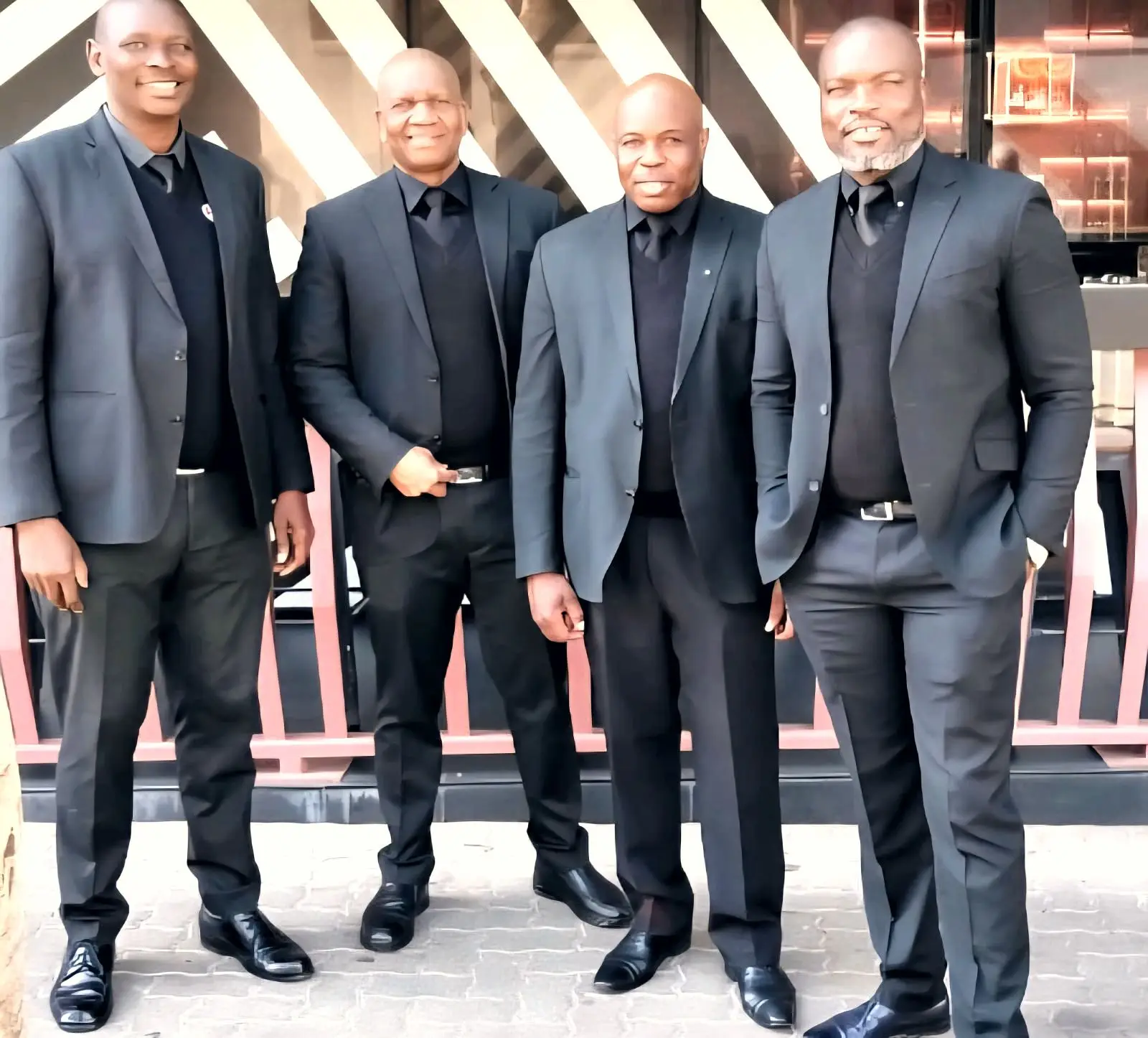 Four ZENOSC managers in dark suits